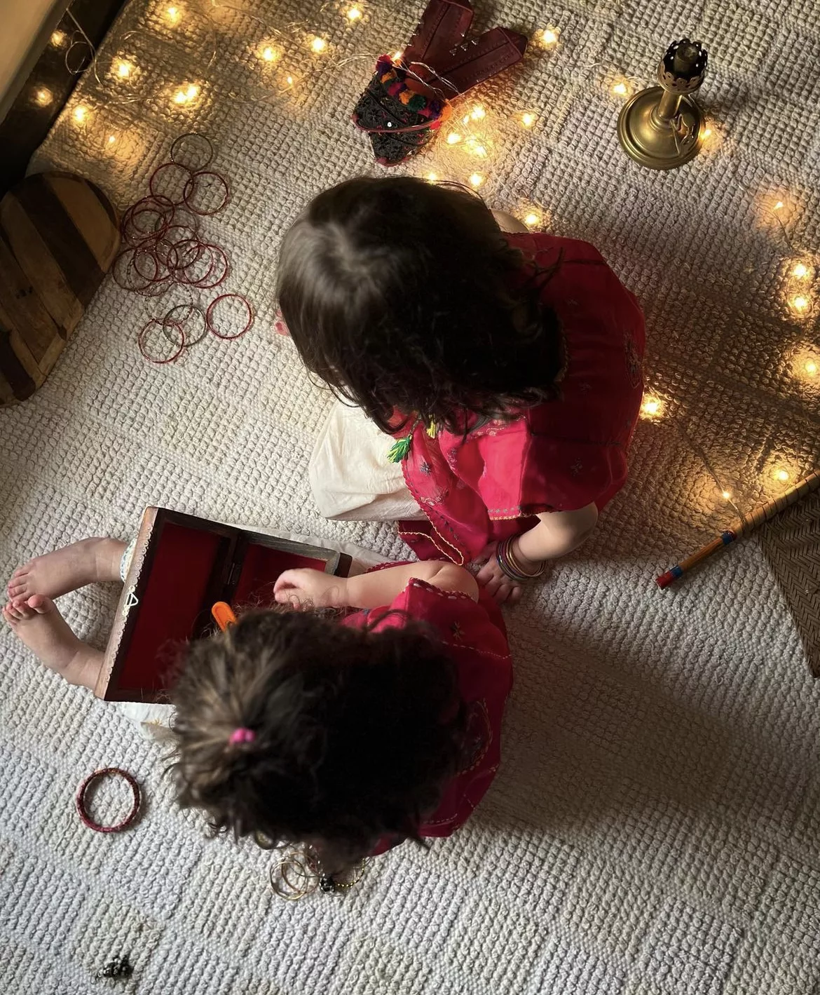 top view of two kids in wearing red oni kids cloths with lights around