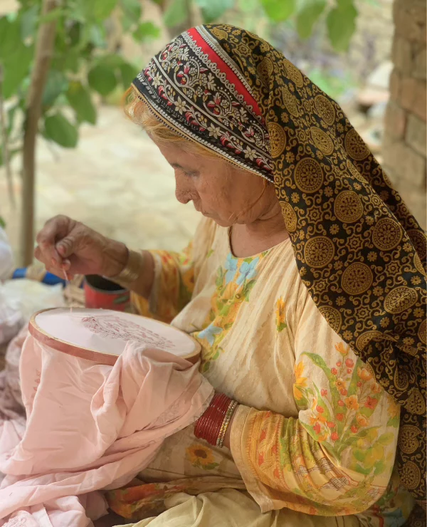 oni-kids-hand-made-cloths A woman making hand stitched cloths